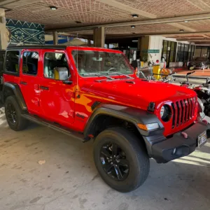 Red 2022 four-door Jeep with open-air design