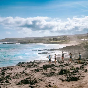 Group hiking along coastal trail at sunset