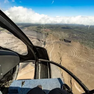 Helicopter flying over volcanic landscape near Hilo