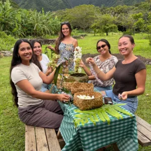 Hands crafting a colorful flower lei