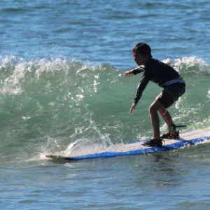 Instructor teaching surfing techniques on Maui beach