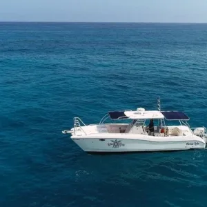 Scuba divers preparing gear on boat for two-tank dive