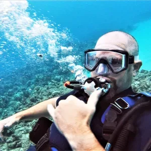 Diver refreshing certification with guided scuba session