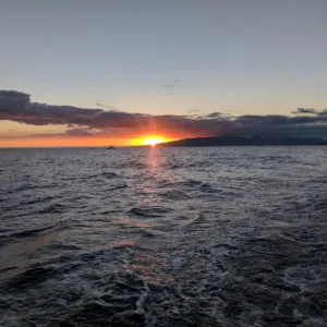Cruise boat sailing along Waikiki coast with guests