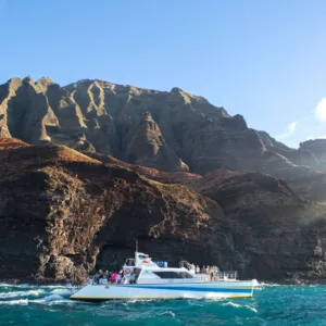 Sunset dinner cruise along Na Pali Coast cliffs