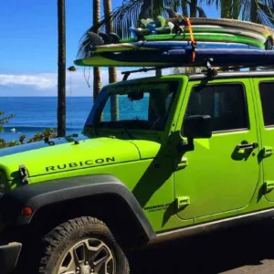 Riding waves during the Maui surf safari experience
