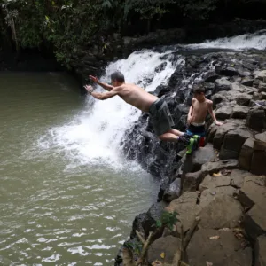 Walking beside a peaceful waterfall in Maui