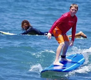 Instructor giving private surfing lesson on Maui beach