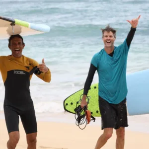 Surf instructor teaching waves to beginners