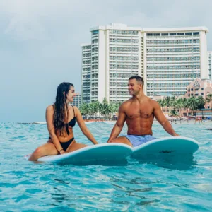 Couple enjoying a private surfing lesson together