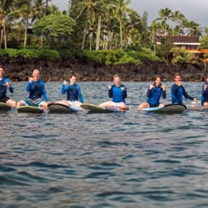 Group enjoying private surf lesson at sunset