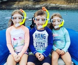 Snorkelers exploring coral reefs at Molokini Crater