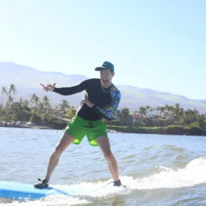 Instructor giving private surf lesson on Maui beach