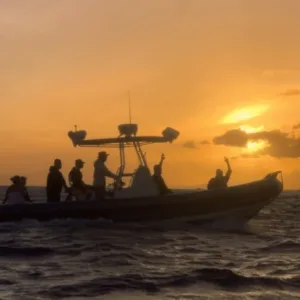 Guests enjoying a sunset cruise with whale watching in Waikiki