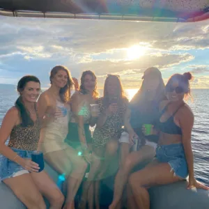 Boat cruising at sunset with vibrant sky colors