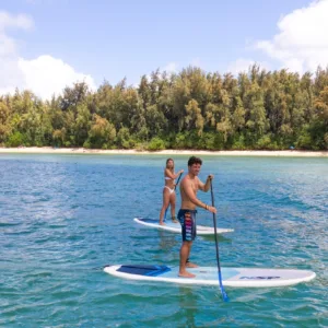 Family paddling together on calm ocean waters