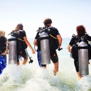 Scuba diver preparing for shore dive near Oahu beach