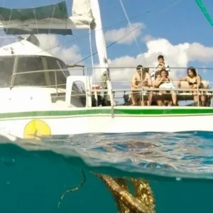 Catamaran sailing through Turtle Canyon with snorkelers aboard