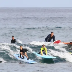 Group of surfers taking lesson together