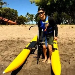 Cyclists riding water bikes across Makena Bay’s clear waters