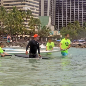 Group of surfers learning together on gentle ocean waves