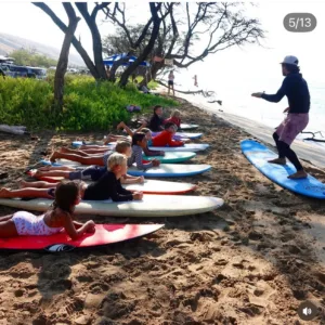Group of three to five people in surf lesson