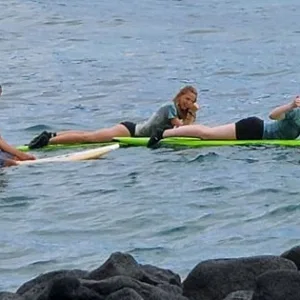 Small group participating in a semi-private surf lesson in Kona