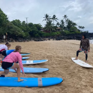 Group of beginners learning to surf together