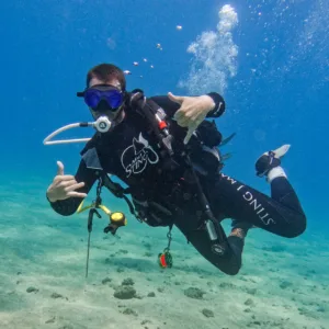 Scuba divers exploring vibrant underwater reefs in Maui