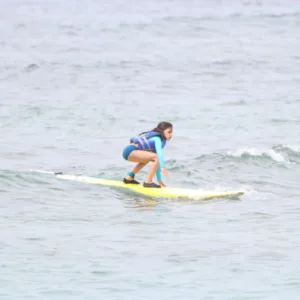 Private surf instructor guiding lesson on tropical island beach