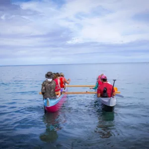Paddling a canoe around a tropical island