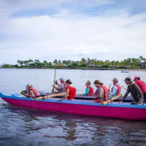 Couple enjoying a peaceful canoe ride on clear ocean waters
