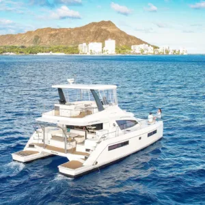 Private charter boat cruising near Waikiki beach shore