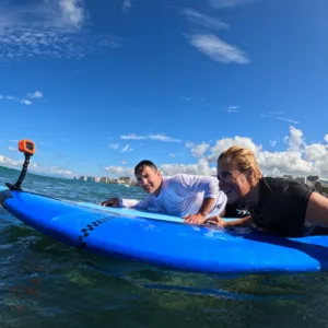 Two people enjoying a private surf lesson in Waikiki