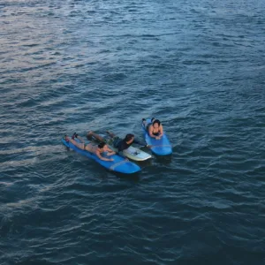 Small group of three taking a private surf lesson together