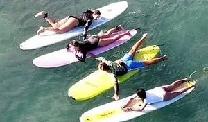 Group of four taking private surf lesson together