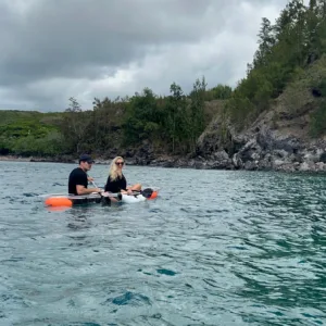 Clear bottom kayak floating over vibrant coral reefs in Maui