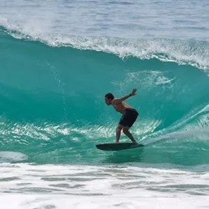 Instructor guiding student during private surf lesson