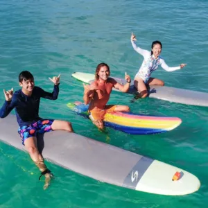 Instructor guiding student during semi-private surf lesson