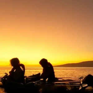Clear kayak gliding at sunset over Olowalu waters