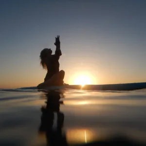 Yoga session on paddleboard during vibrant sunset