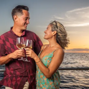 Sunset sailboat with cocktails on calm ocean waters