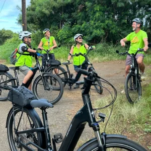 Cyclists riding e-bikes through scenic Poipu and Koloa area