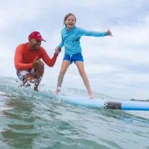 Beginner surfers catching waves at Kapolei beach