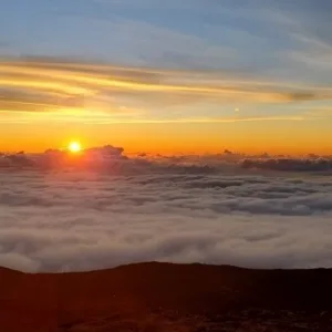 Explorers hiking rugged terrain in West Maui mountains