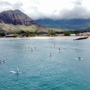 Stand up paddleboarders learning at Pokai Bay calm waters