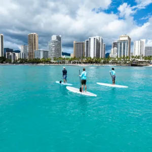 Family trying stand up paddleboarding in Waikiki waters
