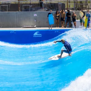 Surfer riding a massive 65ft wave in ocean