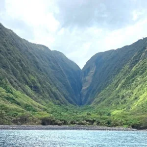 Hikers exploring epic waterfalls and valleys during island adventure