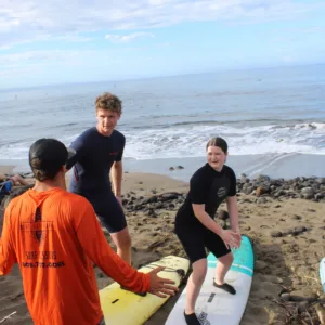 Advanced surfers catching waves on a sunny day